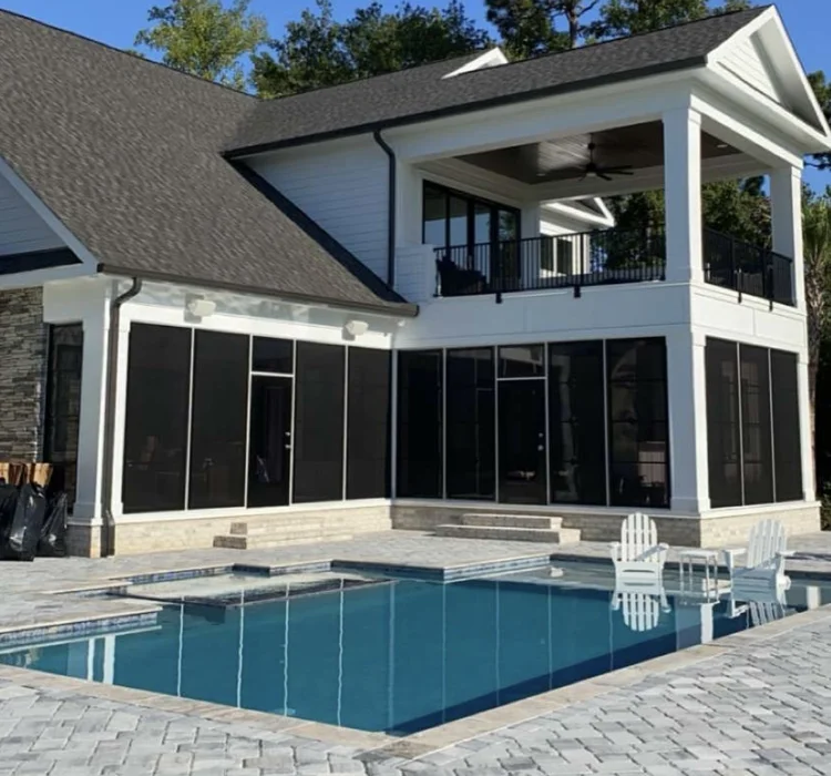 Two-story Breeze Boys screened porch and covered balcony overlooking a pool